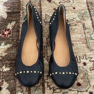 J Crew size 7 black leather flats with rubber sole and gold studs.